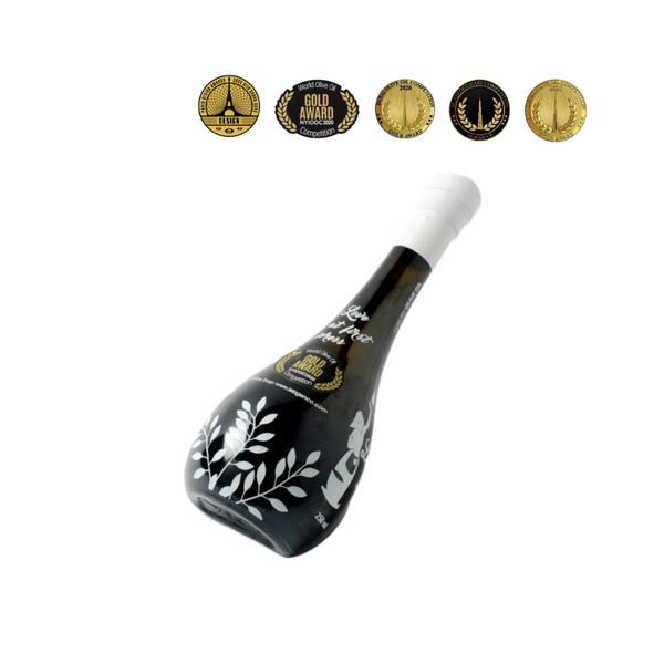 A bottle of Family Reserve Extra Virgin Olive Oil with a black and white design, adorned with olive branch illustrations and award seals indicating its quality.